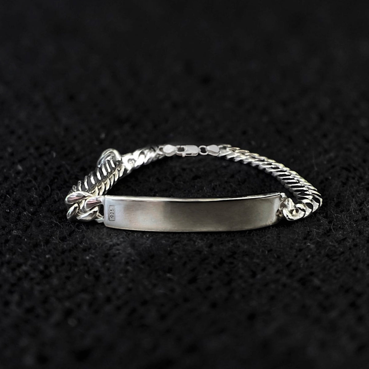 Men's Sterling silver ID bracelet featuring an engraved 925 hallmark plaque and substantial chain. Custom engravable luxury bracelet.