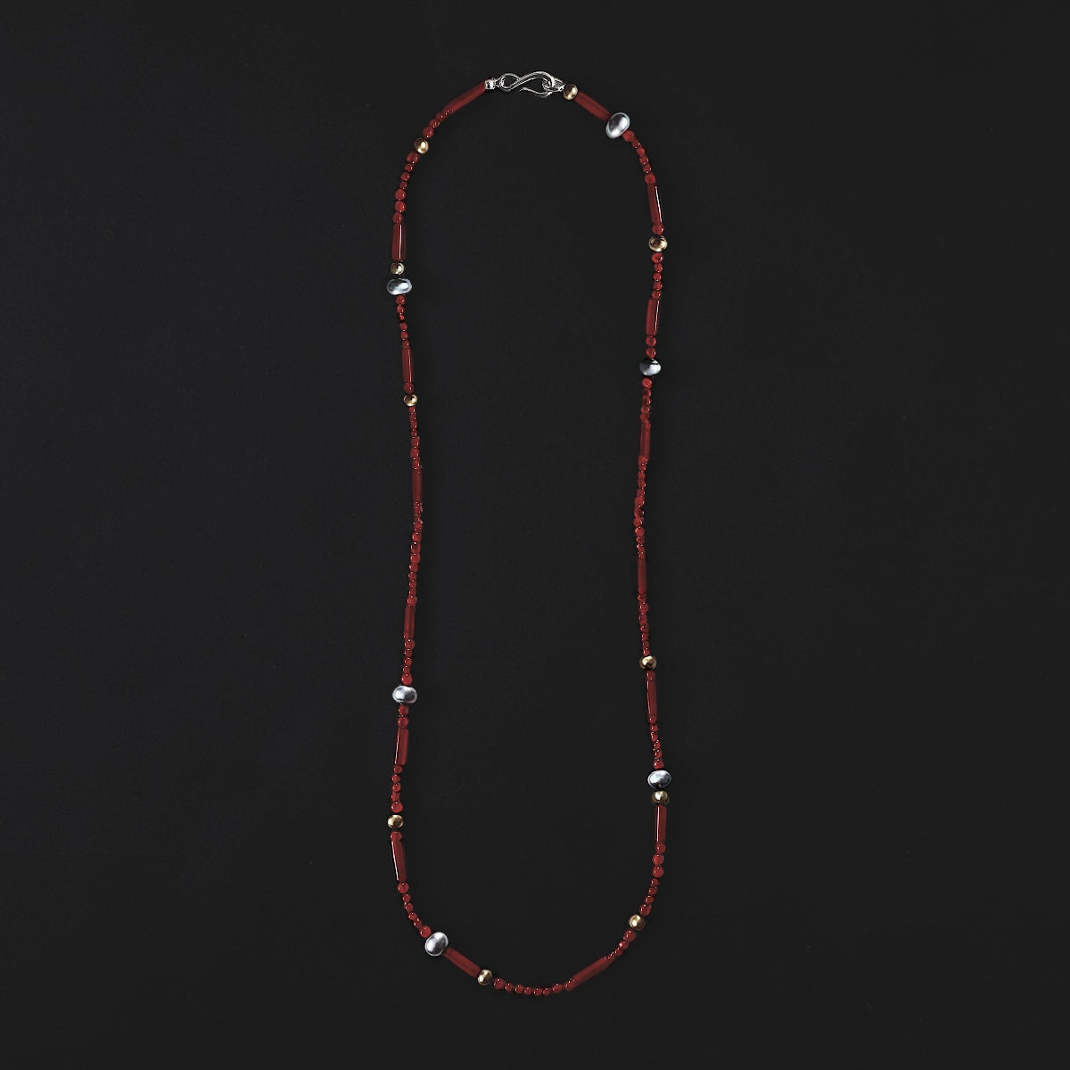 Lustrous shining pearls paired with  brilliant carnelian as a part of the Lucent Pearl long Necklace.