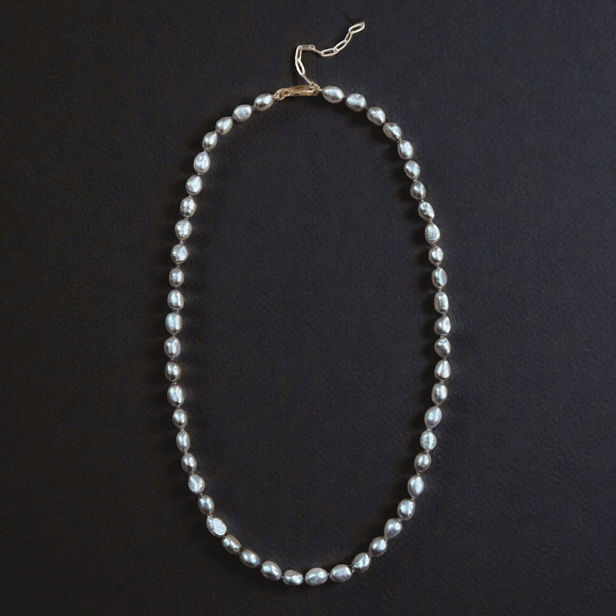 Long grey Keshi pearl necklace featuring naturally shaped luminous pearls hand-strung on silk, with a 23-inch strand and 3-inch extender.