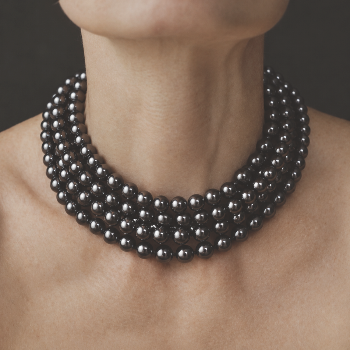 Strata luxury multi-strand statement collar necklace featuring polished hematite beads in a layered design.