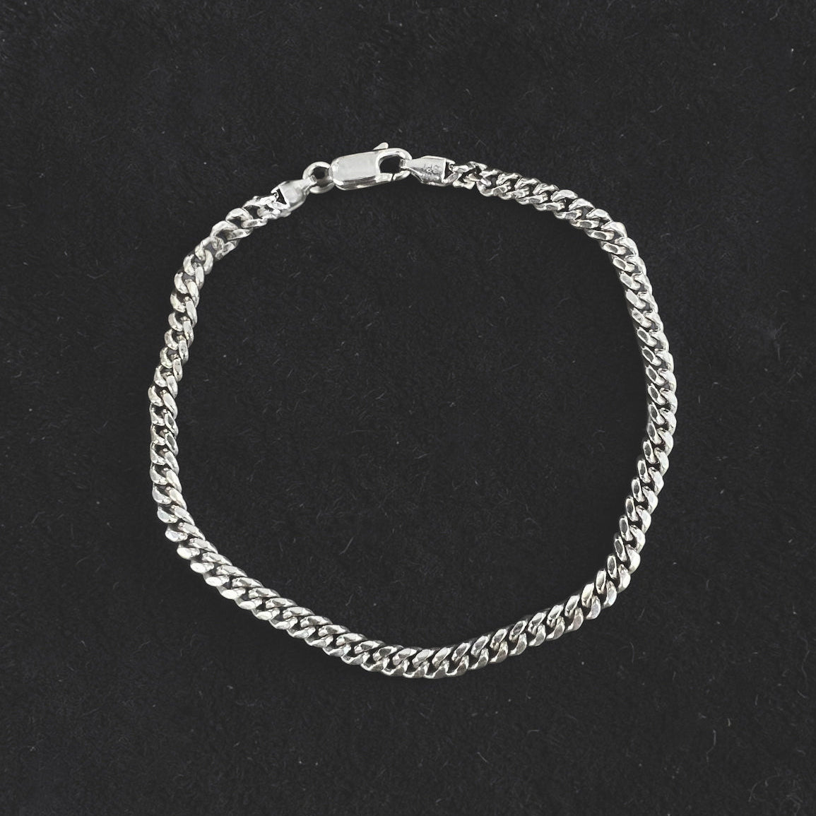Luxury men's Sterling silver curb chain bracelet with polished links and a refined minimalist design.