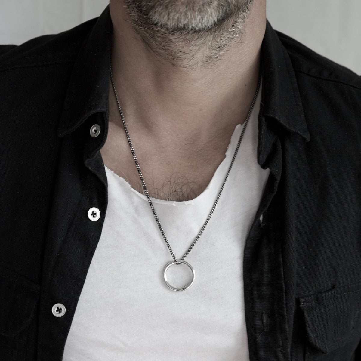 Luxury men's Sterling silver Eternity pendant necklace with engraved 925 hallmark and bezel-set white diamond on a curb chain.