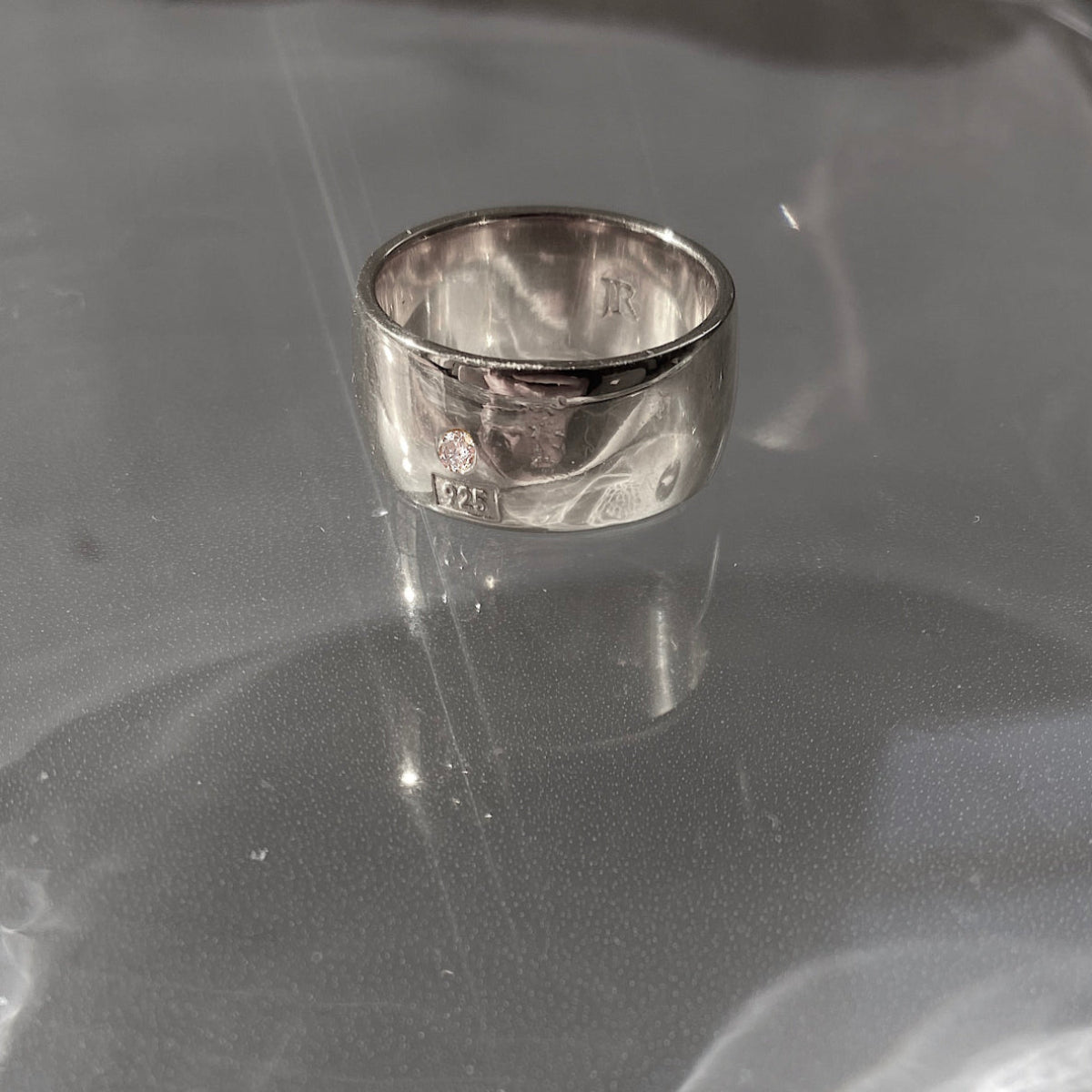 Luxury men's Hallmark cigar band ring with engraved 925 detail and bezel-set white diamond.