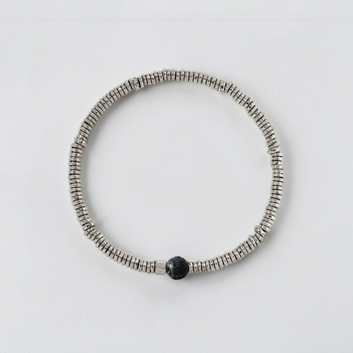 Luxury men's stretch bracelet with natural lava stone beads and organic white brass heishi accents.