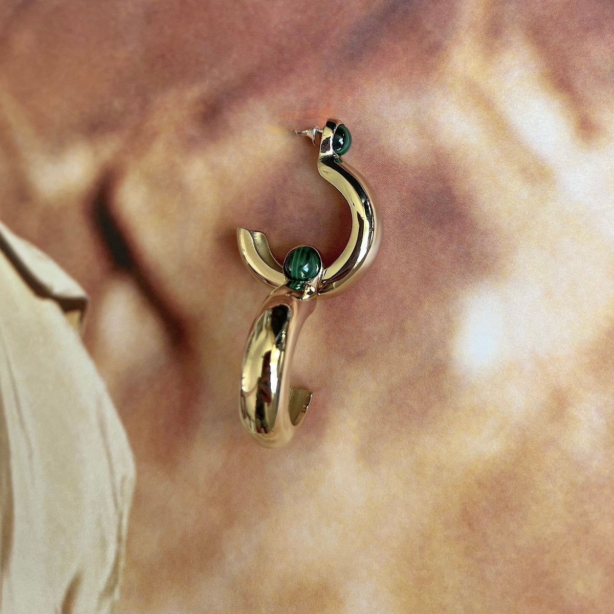 Women's Pebble hoop earrings featuring natural malachite cabochons in a high-polished gold-plated setting. Lightweight luxury designer earrings and modern heirloom jewelry.