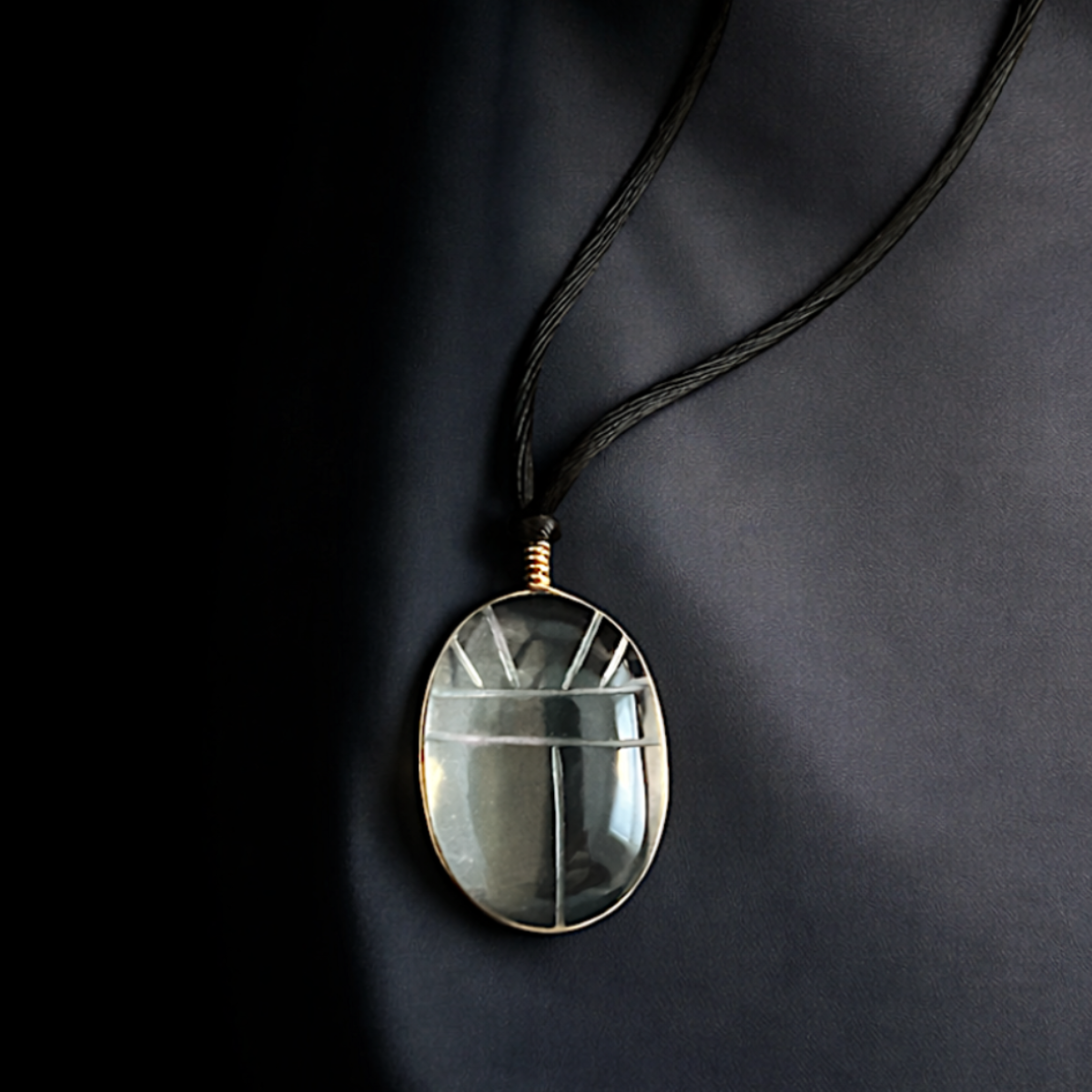 hand carved clear quartz scarab necklace wrapped in gold vermeil wire on black silk cord. modern talisman jewelry