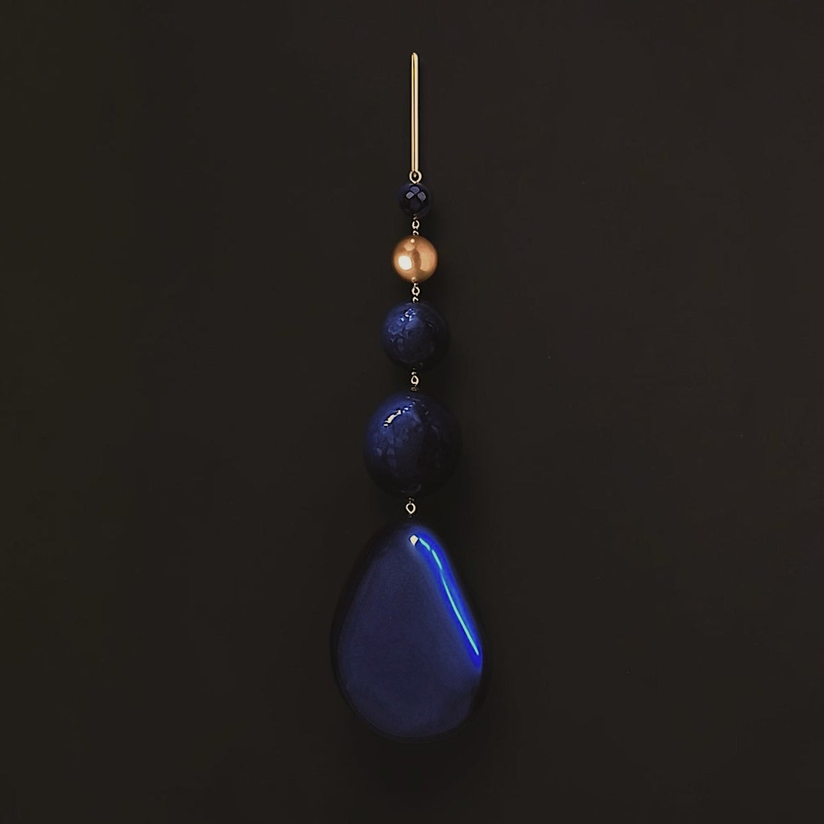 Hera sculptural statement earrings featuring polished black onyx, faceted blue lapis lazuli and delicate gold-filled chains.