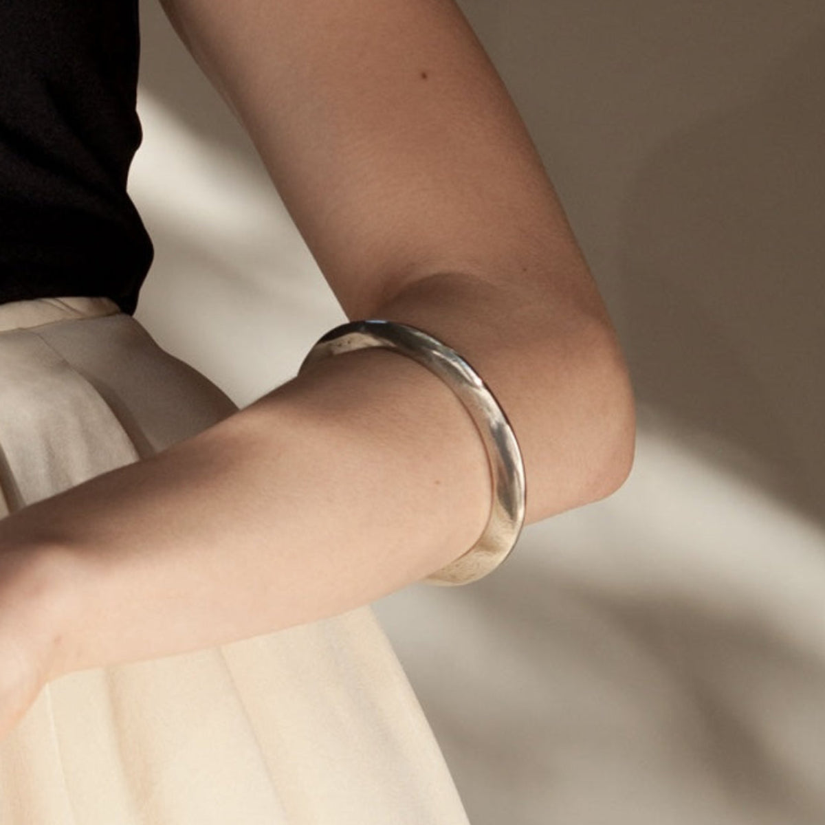 Wedge bangle in Sterling silver and white bronze, sculptural modern statement bracelet by Jacqueline Rose