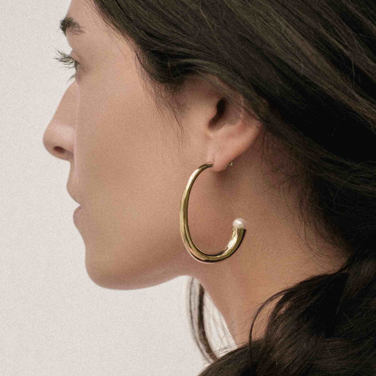 Vine hoop earrings handcrafted in bronze with lustrous freshwater pearls and Sterling silver posts. Luxury pearl hoop earrings and modern heirloom jewelry.